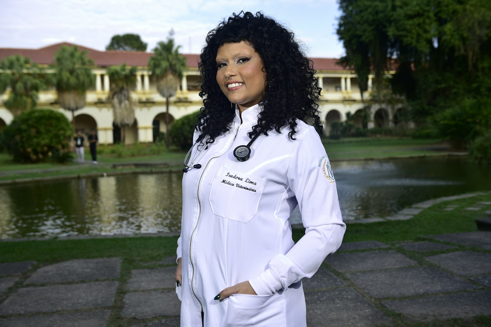 A smiling young woman in a white coat, representing the students and scholarships the Endowment Fund supports