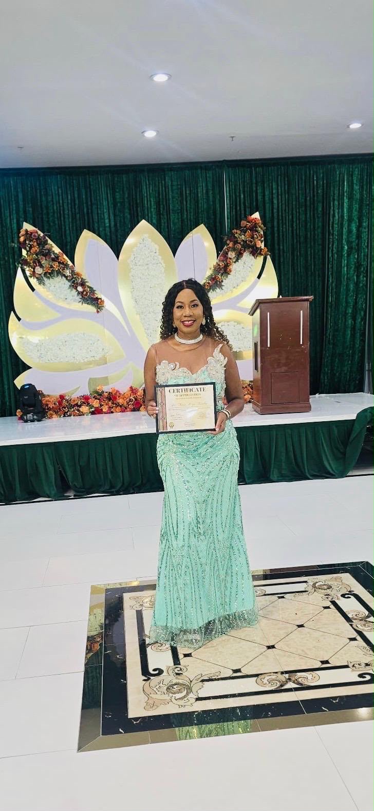 Dr. Nina Mezu-Nwaba holding her Certificate of Appreciation at the 2026 African Cultural Night Awards Ceremony